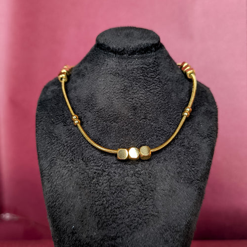 Front view of the Beaded Chain Necklace displayed on a black bust showcasing the polished gold cubes and snake chain.