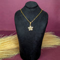 Close-up view of the Five-Pedal Flower Crystal Pendant highlighting the crystal-set petals and gold chain on a black bust.