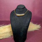 Front view of the Gleaming Bead Curve Bar Necklace displayed on a black bust showcasing the full chain and geometric pendant.
