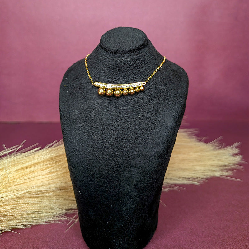 Front view of the Gleaming Bead Curve Bar Necklace displayed on a black bust showcasing the full chain and geometric pendant.