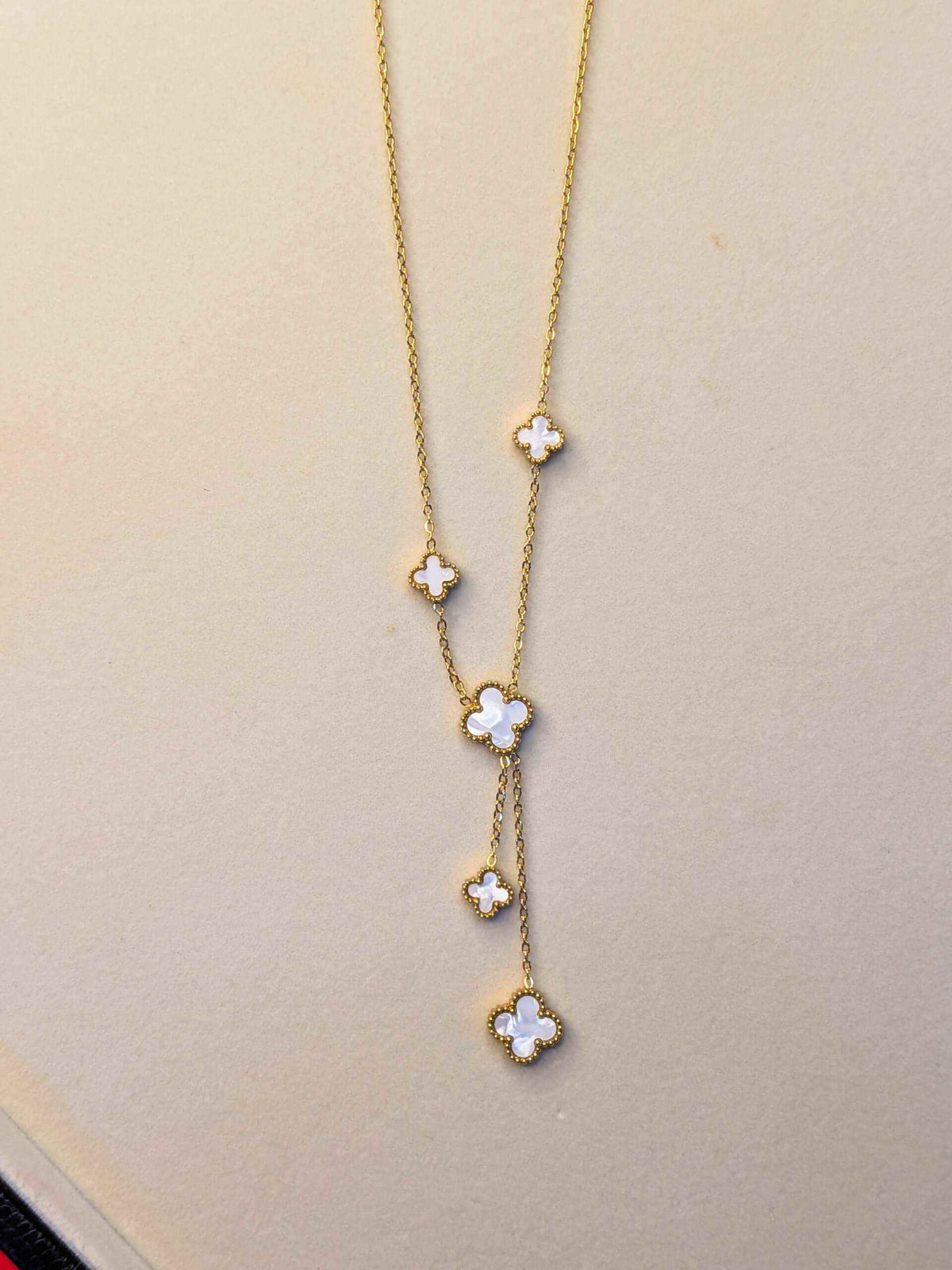 Ivory Clover Cascade Necklace with ivory clover charms on a delicate gold-tone cascading Y-chain