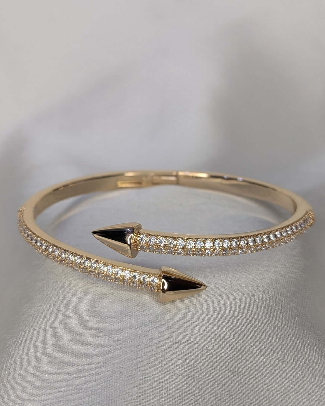 Gold crystal arrow cuff bracelet with open design