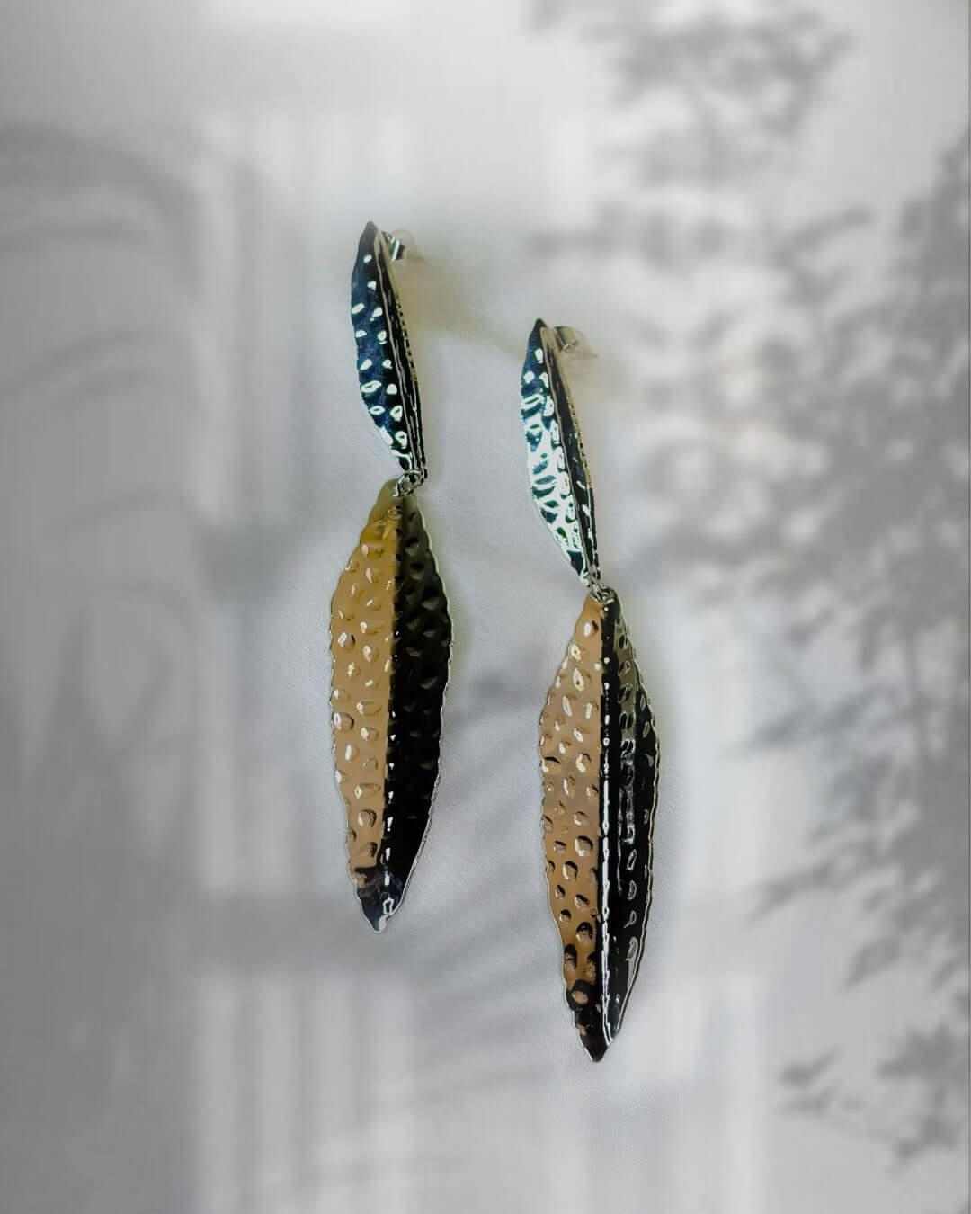 Silver Feather Cascade Earrings with elongated textured feather shapes in silver, gold and black metallic tones