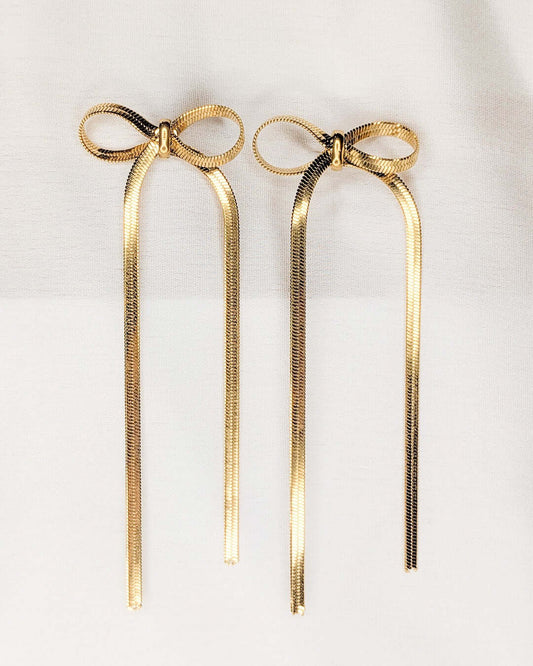 Golden Ribbon Tassel Earrings close-up showcasing elegant bow design and cascading chains