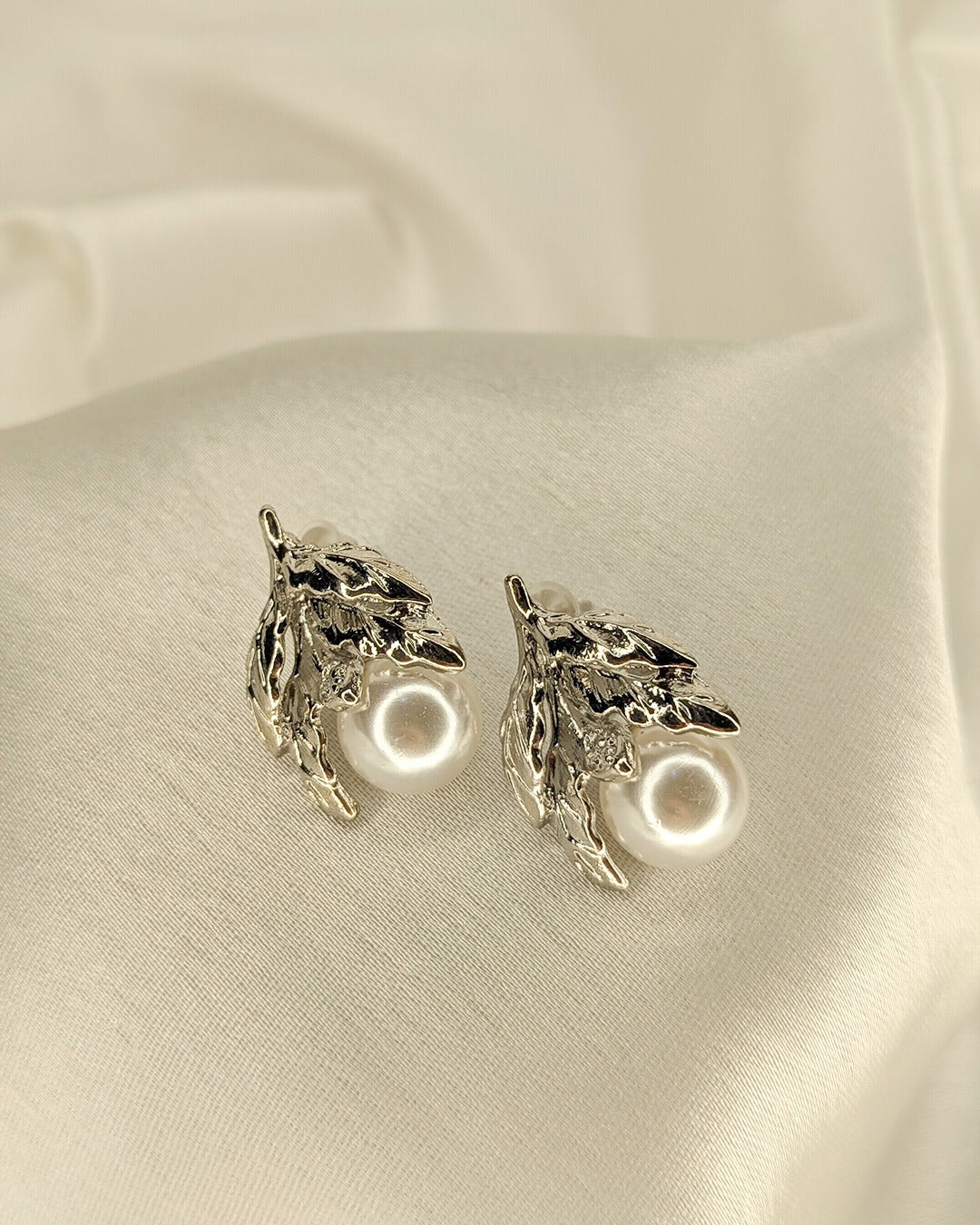 Luxury silver pearl earrings with botanical leaf detailing and timeless styling