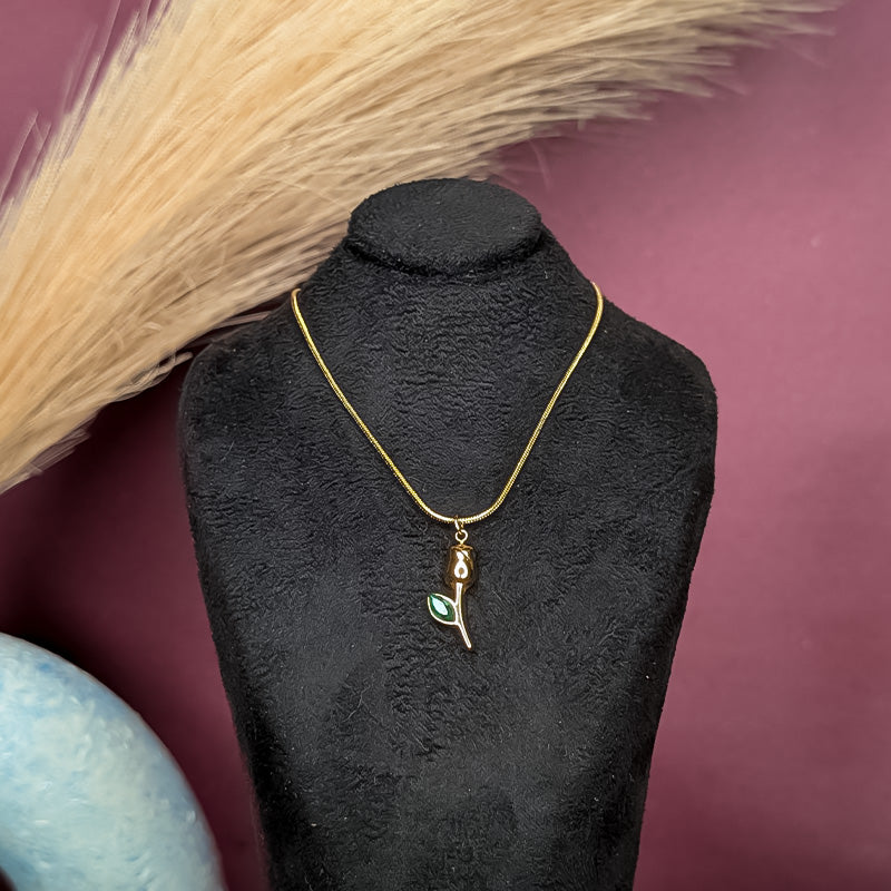 Gold-tone tulip necklace with emerald green leaf pendant